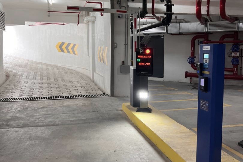 Automated barrier and payment terminal at a car park entry lane