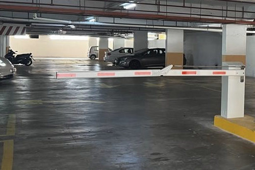 Raised barrier arm at a multi-storey car park lane